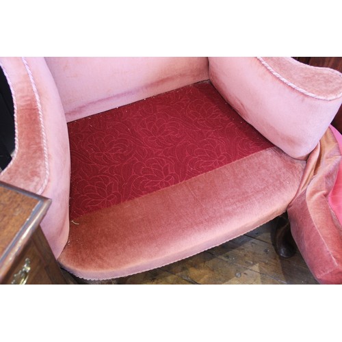 729 - A George III wing back fireside armchair, later re-covered in pink velour with applied rope detail, ... 