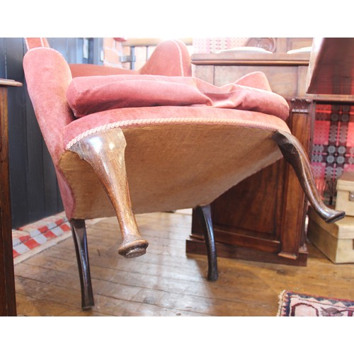 729 - A George III wing back fireside armchair, later re-covered in pink velour with applied rope detail, ... 