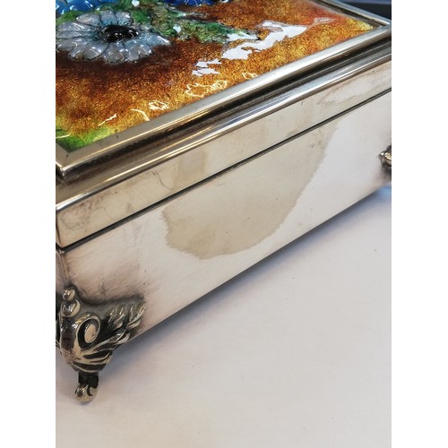 55 - A silver coloured enamelled jewellery casket, of rectangular form raised on four scrolling feet, the... 