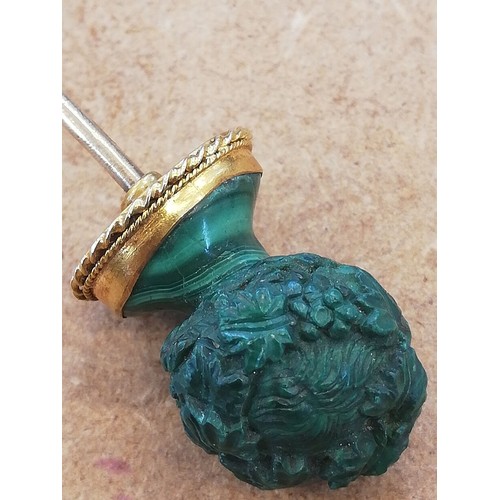 116 - A malachite stick pin, carved in the classical style as a female head with waved hair and a crown of... 