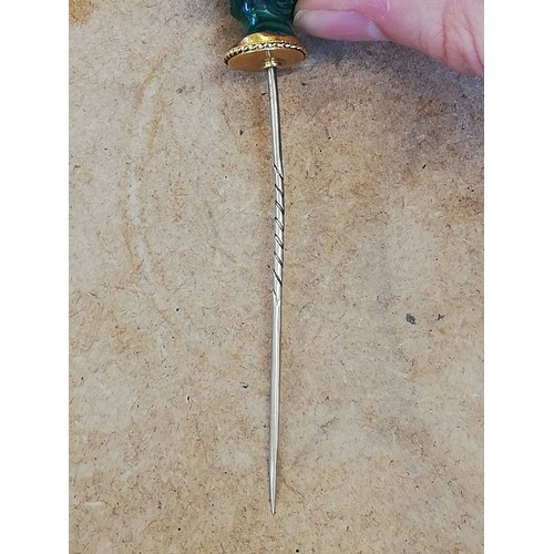 116 - A malachite stick pin, carved in the classical style as a female head with waved hair and a crown of... 