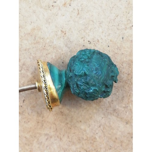 116 - A malachite stick pin, carved in the classical style as a female head with waved hair and a crown of... 