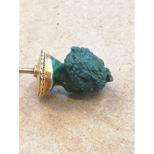 116 - A malachite stick pin, carved in the classical style as a female head with waved hair and a crown of... 