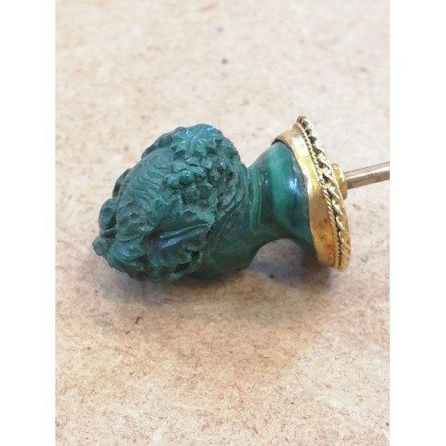 116 - A malachite stick pin, carved in the classical style as a female head with waved hair and a crown of... 