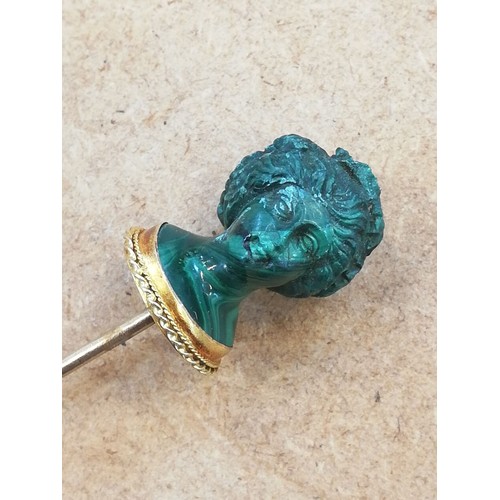 116 - A malachite stick pin, carved in the classical style as a female head with waved hair and a crown of... 