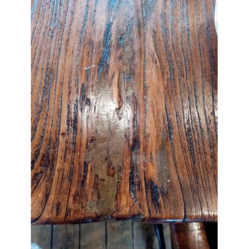 828 - An elm refectory table, late 20th century, the rectangular slab top raised upon two pairs of substan... 