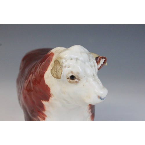 563 - Two Beswick cattle families, comprising: a Jersey Bull, model No. 1422 in gloss, 