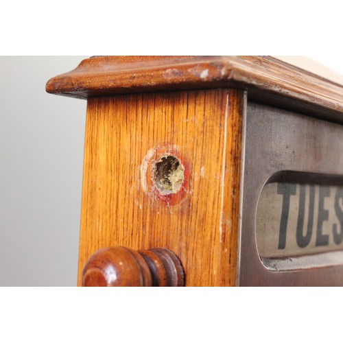 628 - An early 20th century walnut cased perpetual roller desk calendar, of architectural form, the roller... 