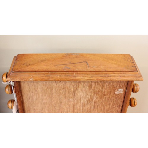 628 - An early 20th century walnut cased perpetual roller desk calendar, of architectural form, the roller... 