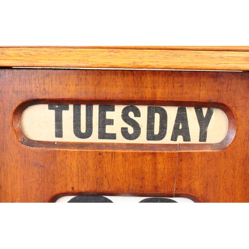 628 - An early 20th century walnut cased perpetual roller desk calendar, of architectural form, the roller... 