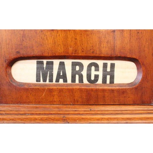 628 - An early 20th century walnut cased perpetual roller desk calendar, of architectural form, the roller... 