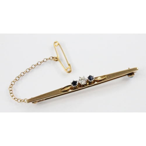 102 - A diamond and sapphire 18ct gold bar brooch, the central round brilliant cut diamond weighing approx... 