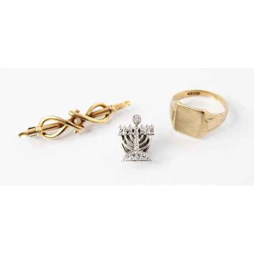 117 - A diamond set minora dress pin, modelled in white metal as a seven branch minora with a brilliant cu... 