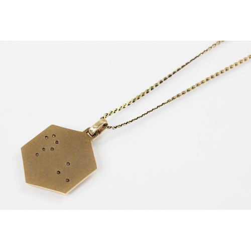 122 - A diamond set 'Leo' pendant charm, the hexagonal gold coloured pendant charm engraved with the const... 