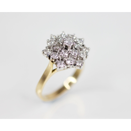 132 - A diamond cluster ring, designed as a tiered hexagonal cluster of nineteen round brilliant cut diamo... 