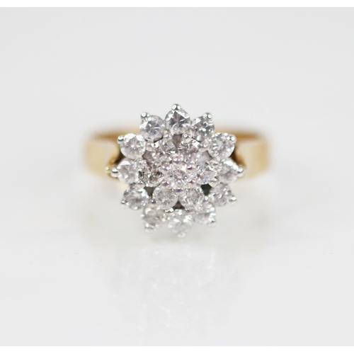 136 - A diamond floral cluster ring, designed as a tiered cluster of nineteen round brilliant cut diamonds... 