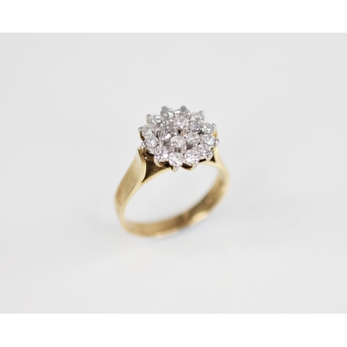 136 - A diamond floral cluster ring, designed as a tiered cluster of nineteen round brilliant cut diamonds... 