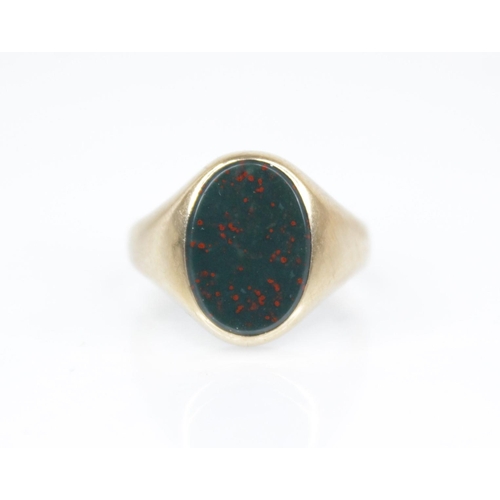 139 - A 9ct gold bloodstone set signet ring, the oval plain polished bloodstone matrix measuring 13.2mm x ... 