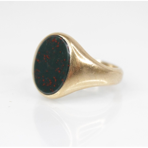 139 - A 9ct gold bloodstone set signet ring, the oval plain polished bloodstone matrix measuring 13.2mm x ... 