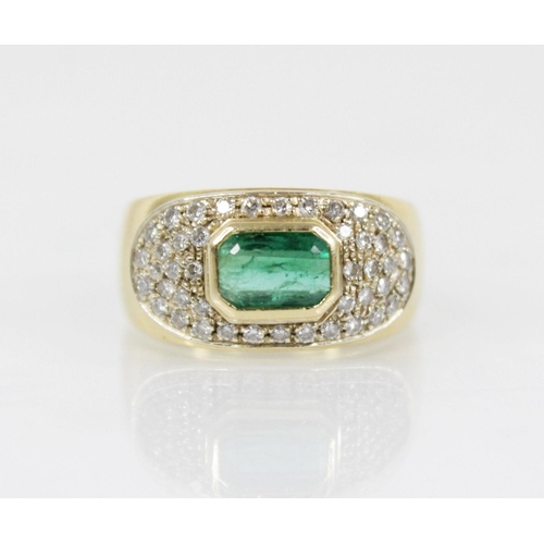 154 - An Italian emerald and diamond 18ct gold ring, designed as a central rectangular step cut emerald me... 