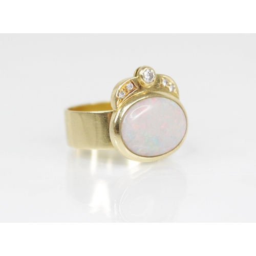 155 - An Italian opal and diamond 18ct gold ring, the central oval opal cabochon measuring 13.5mm x 10mm, ... 