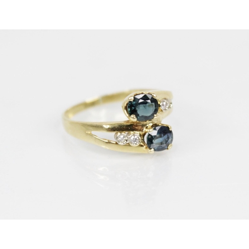 158 - A continental sapphire and diamond 18ct gold crossover ring, designed as two oval mixed cut sapphire... 