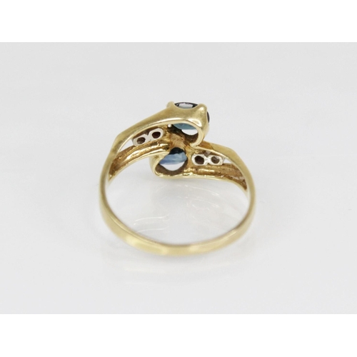 158 - A continental sapphire and diamond 18ct gold crossover ring, designed as two oval mixed cut sapphire... 