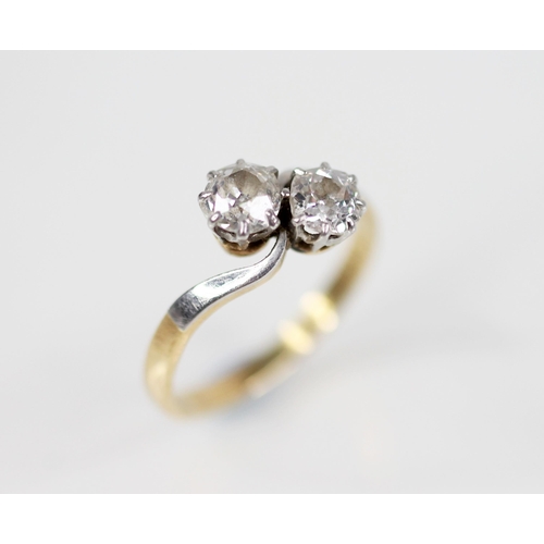 159 - A diamond crossover ring, designed as two old mine cut diamonds, one measuring 4.82mm x 4.3mm 2.82mm... 