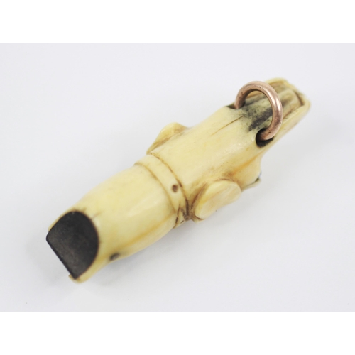 171 - A Victorian carved ivory dog whistle, modelled as a hound with glass eyes and gold coloured ring to ... 