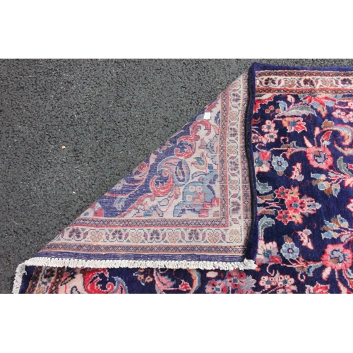 483 - An Iranian blue ground floor runner, the central floral medallion enclosed by trailing foliate motif... 