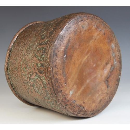 593 - An Indian copper vessel, 19th century, of tapering form, the sides extensively decorated with a cont... 