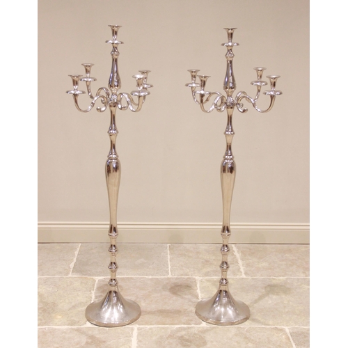 598 - A pair of contemporary chromed metal floor standing candelabra, each with four 'S' shaped branches u... 