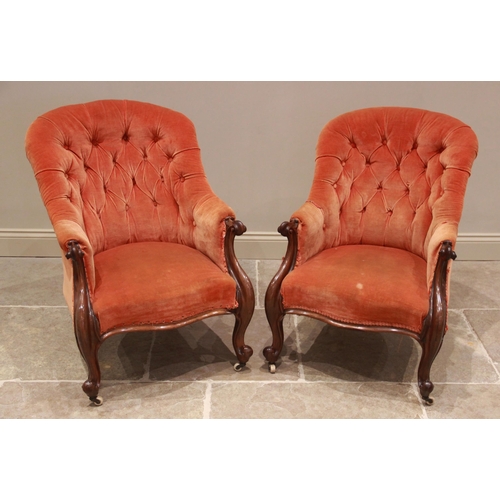 723 - A pair of Victorian rosewood tub type armchairs, later re covered, the button backs extending to car... 