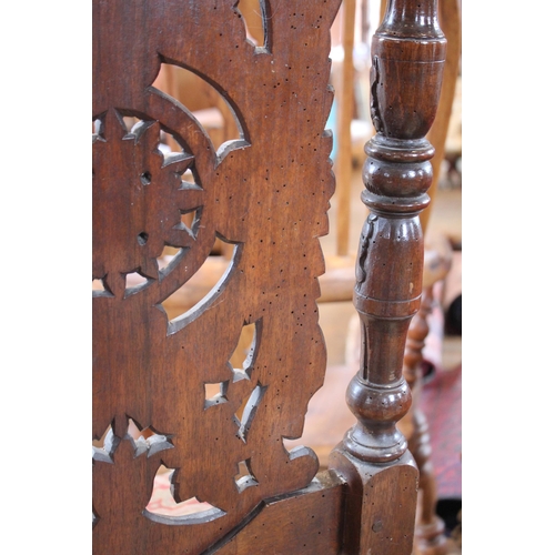 735 - A carved walnut Carolean style hall chair, 19th century, the carved foliate and 'C' scroll high back... 