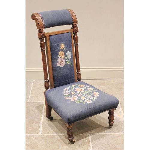 737 - A Victorian walnut and upholstered prie-dieu chair, the padded back flanked by acanthus carved pilas... 