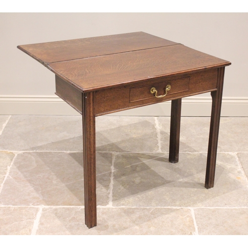 740 - A 19th century oak tea table, the rectangular moulded folding top above a single frieze drawer, rais... 