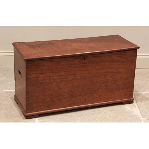 745 - An early 20th century oak blanket chest, with campaign style inset brass side handles, raised upon b... 