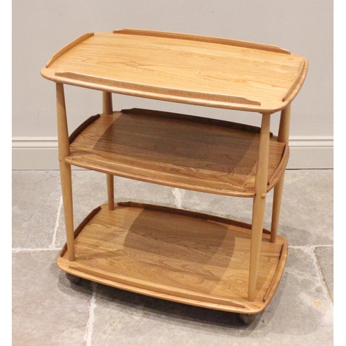 759 - An Ercol light elm drinks trolley, mid-20th century, the three galleried shelves raised on turned su... 