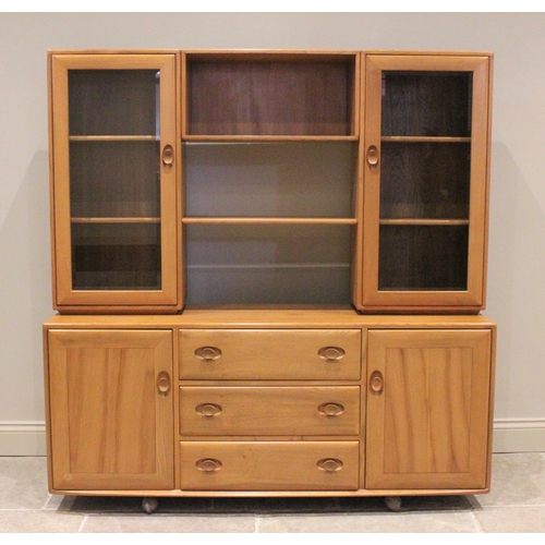 760 - An Ercol light elm high board, mid 20th century, the base with three equal drawers (the top one with... 