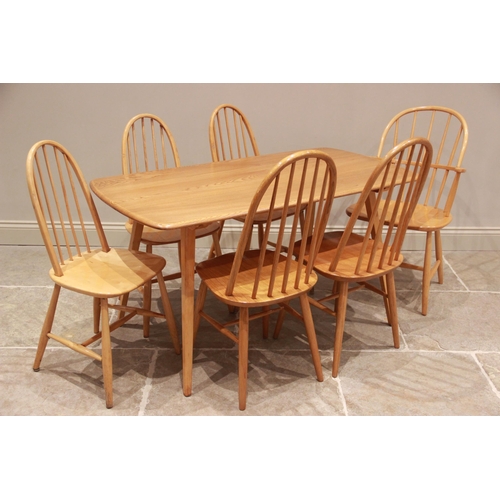 771 - A mid 20th century Ercol style blonde elm and beech wood kitchen table, the rectangular top on splay... 