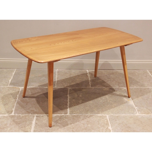 771 - A mid 20th century Ercol style blonde elm and beech wood kitchen table, the rectangular top on splay... 