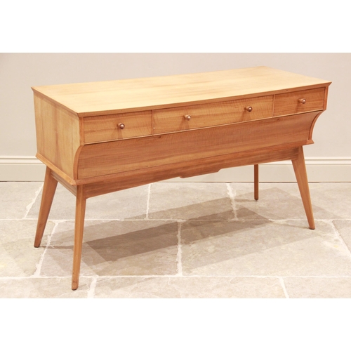 777 - A walnut dressing table by Alfred Cox for Maples, mid 20th century, the long central drawer with sho... 