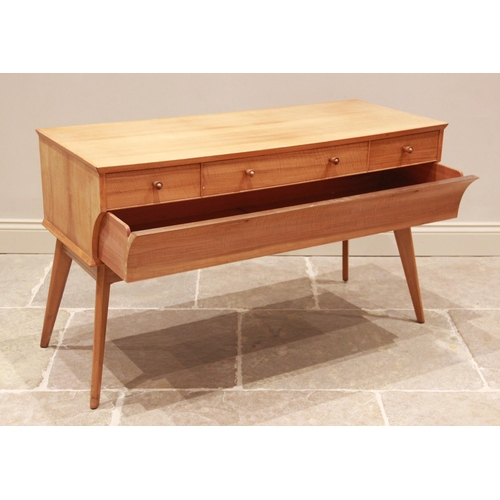 777 - A walnut dressing table by Alfred Cox for Maples, mid 20th century, the long central drawer with sho... 