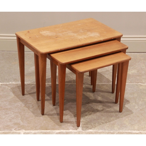 784 - A mid 20th century teak nest of three tea tables by Gordon Russell of Broadway, each table with a re... 