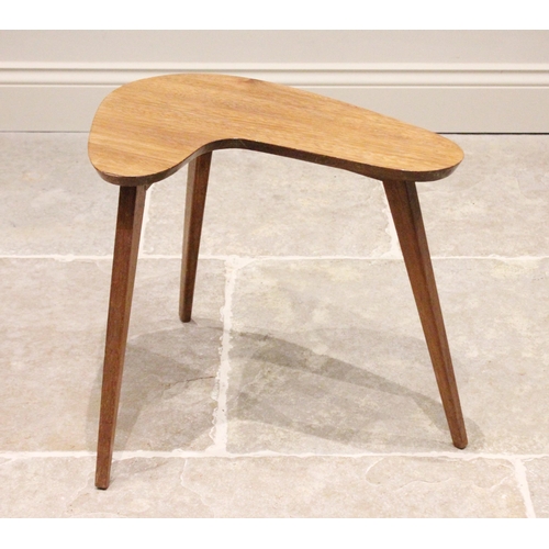 786 - A mid 20th century teak boomerang table, the elongated shaped top raised upon three legs of tapering... 