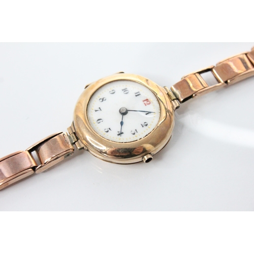 83 - A George V ladies 9ct gold wristwatch, the round white dial with Roman numerals, set to a plain poli... 