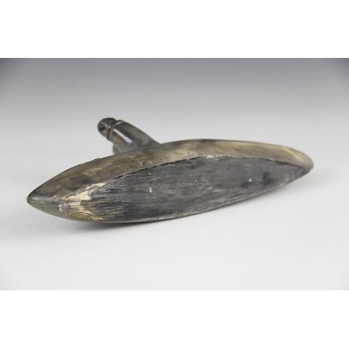 176 - A Inuit stone carving, modelled as a fisherman in a canoe/Umiak, 24.5cm long