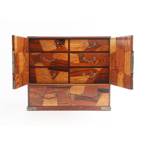 443 - A Japanese rosewood, parquetry and mother of pearl cabinet, early 20th century, the brass mounted do... 