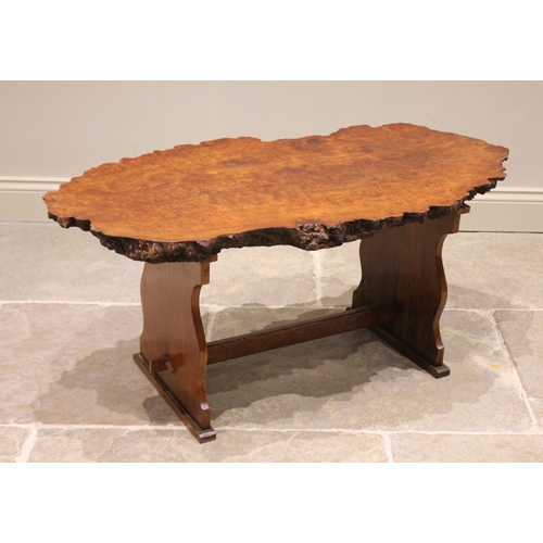 785 - A mid 20th century yew wood coffee table in the manner of Reynolds of Ludlow, the rough cut slab top... 