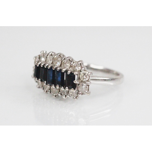 90 - A sapphire and diamond cluster ring, the central boat shaped cluster comprising five graduated bague... 